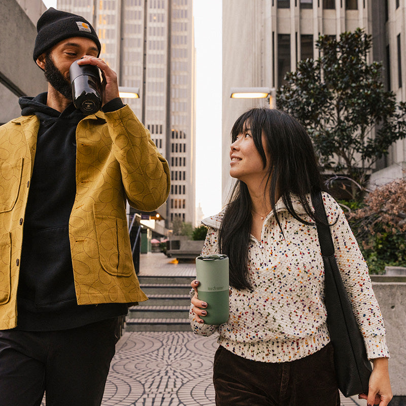 16oz-rise-tumbler-o2 16oz_rise_tumbler_black_iceberg_couple_drink_city_street_square.jpg