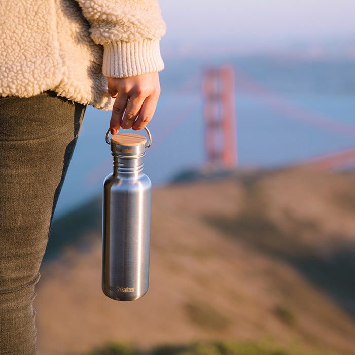 27oz-reflect-with-bamboo-cap-n7 K27SSLRF-BS-BAMBOO_reflect_bottle_bridge_lifestyle.jpg